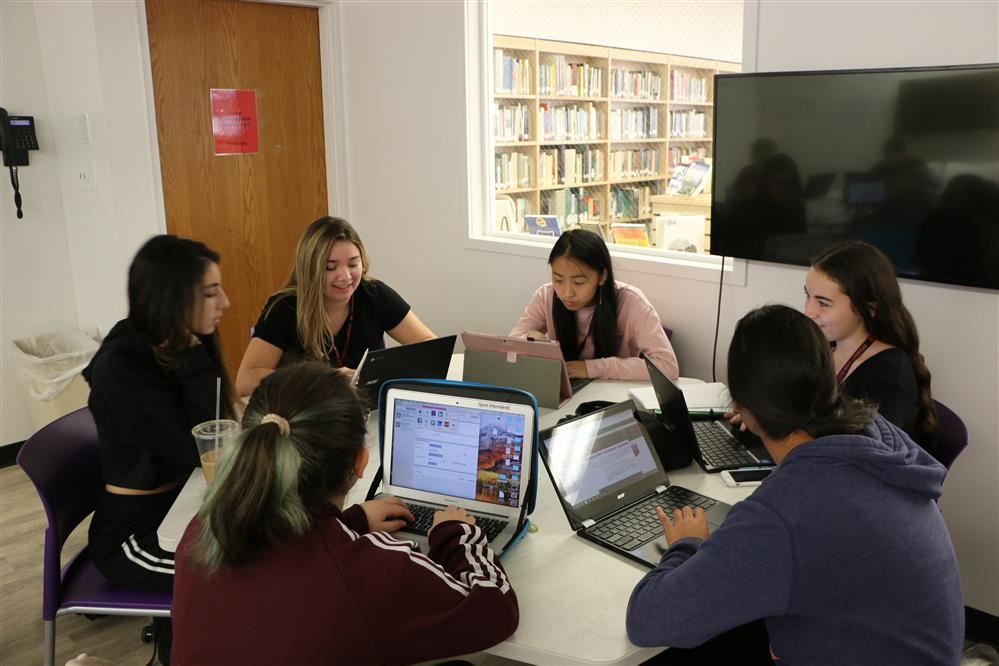 Students working together with chromebooks