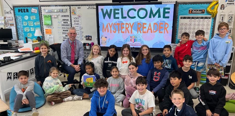  Dr. Rogers posing with a fourth grade class.