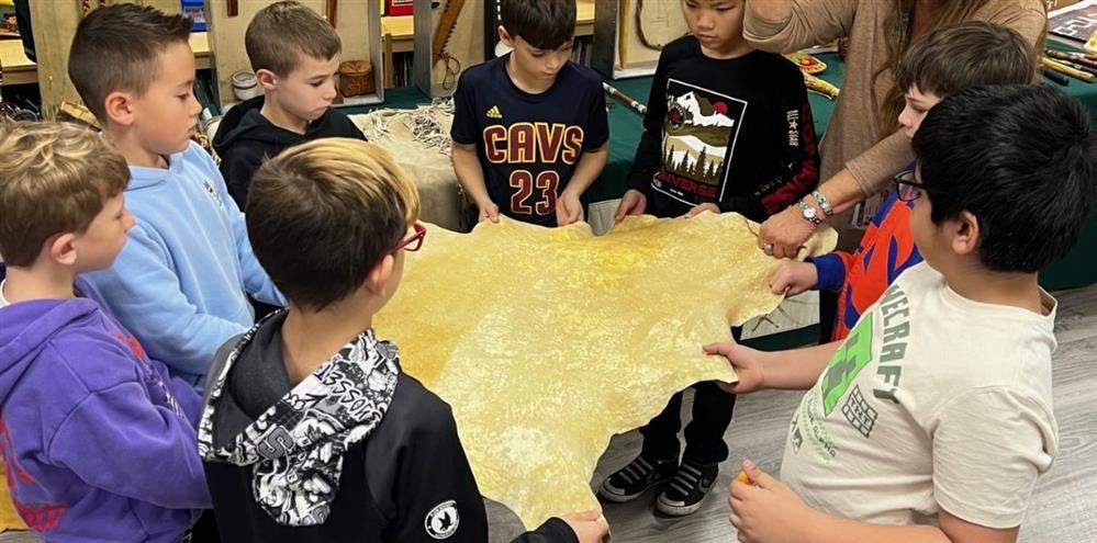   Fourth graders having a Native American experience.