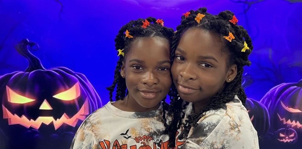  Two fourth graders posing for a Halloween picture.